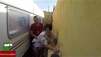 Fat woman wants to eat her pussy in a corner behind the mobile home